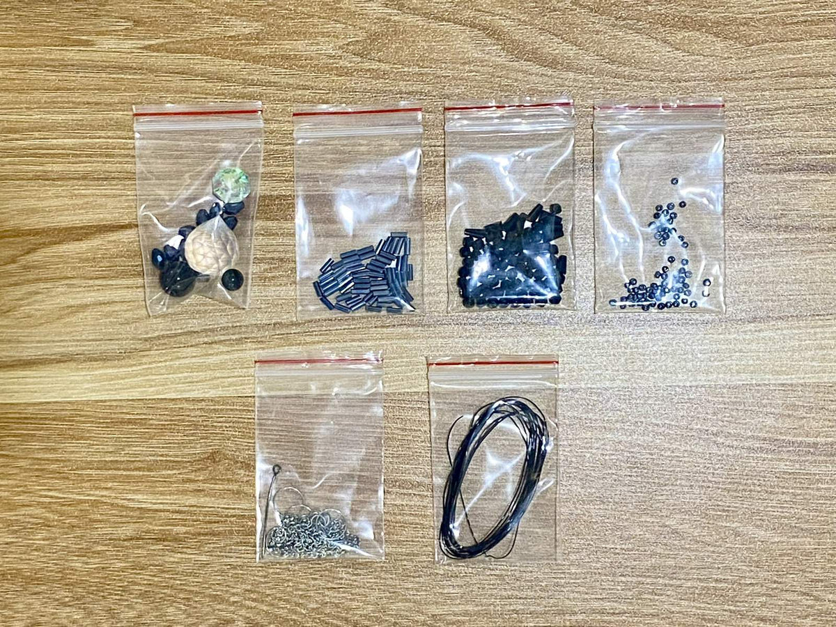Black Widow Suncatcher DIY Kit - materials laid out (Black)