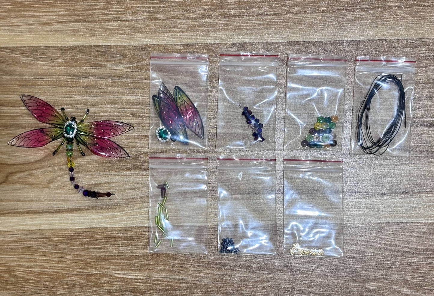 Dragonfly Suncatcher DIY Kit materials laid out - Pink