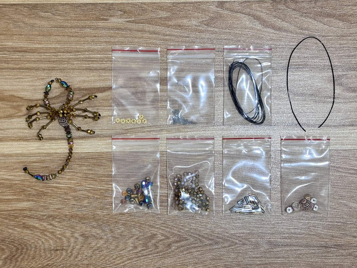 Scorpion Suncatcher DIY Kit - materials laid out (Gold)
