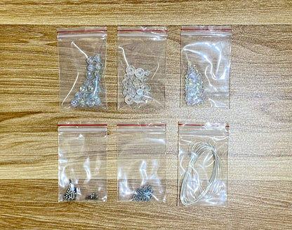 Snowflake Suncatcher DIY Kit - materials laid out (style 1)